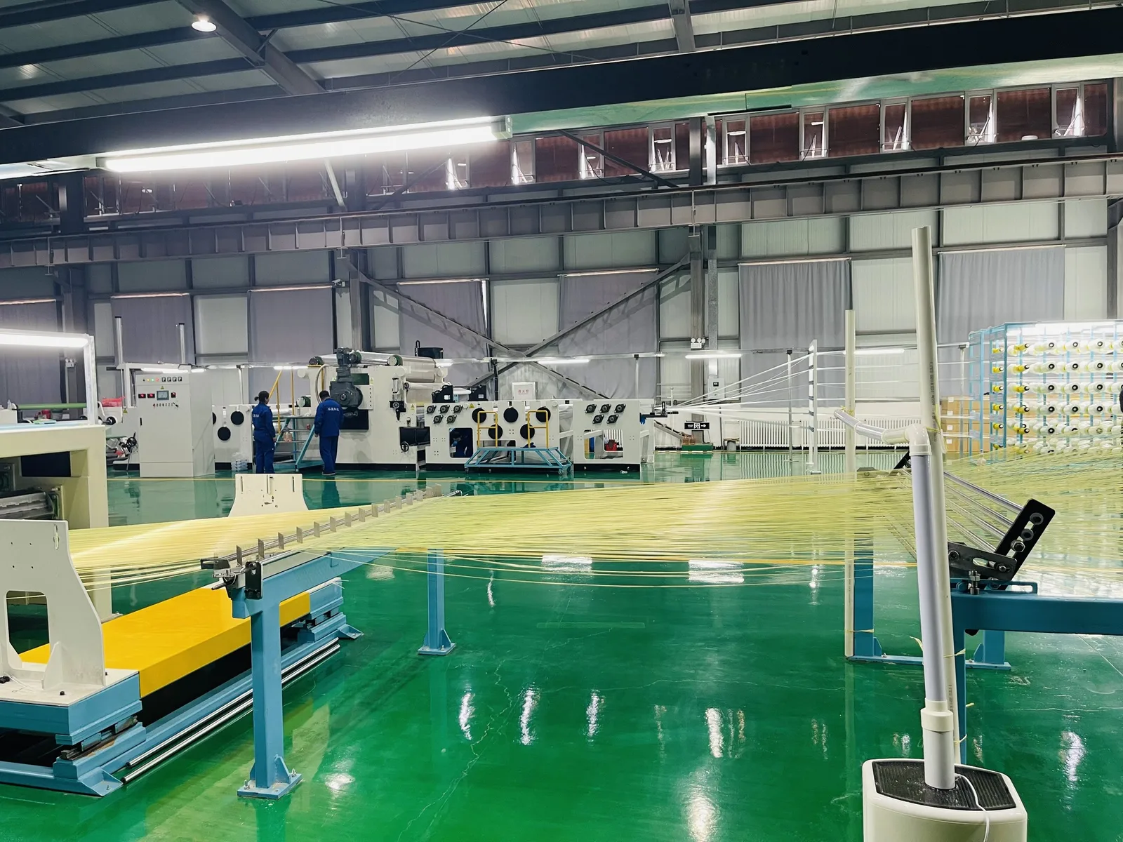 Warping line drawing para-aramid yarn into a parallel sheet