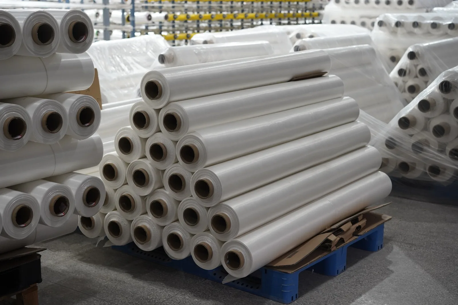 Finished UHMWPE UD fabric rolls wrapped and stacked on pallets